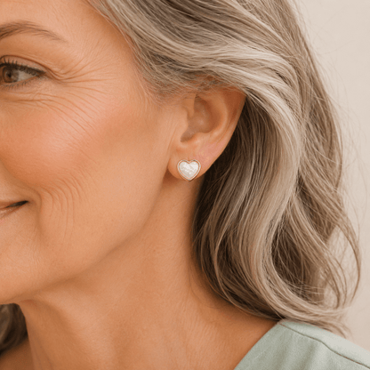 Heart shaped keepsake earrings on an older female model